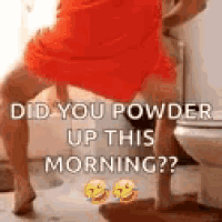 a woman in an orange dress is standing next to a toilet in a bathroom .