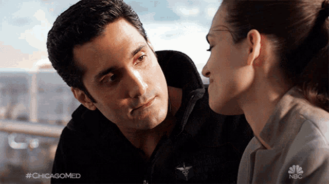 a man and a woman are looking at each other with #chicagomed written on the bottom right