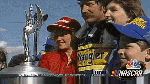 a woman wearing a wrangler shirt stands next to a man and two children