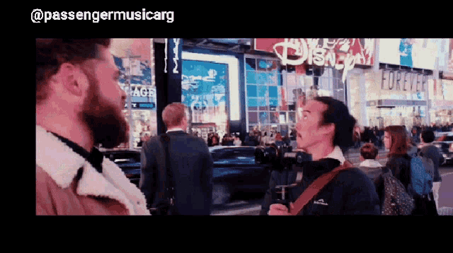 a man standing in front of a sign that says disney