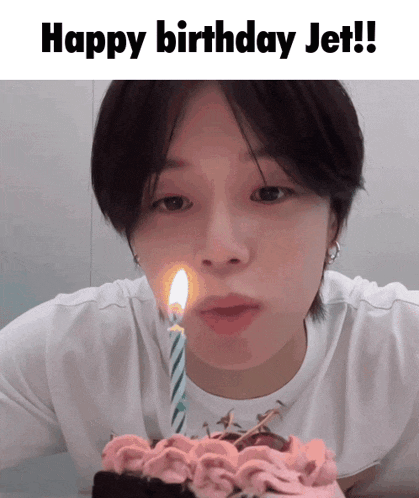 a person blowing out a candle on a birthday cake with the words happy birthday jet below them