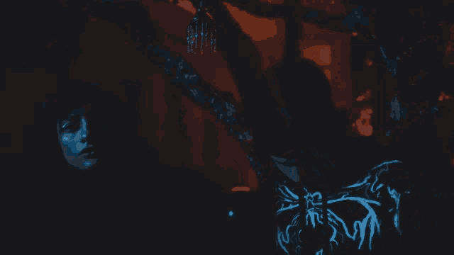 a man and a woman are standing in a dark room