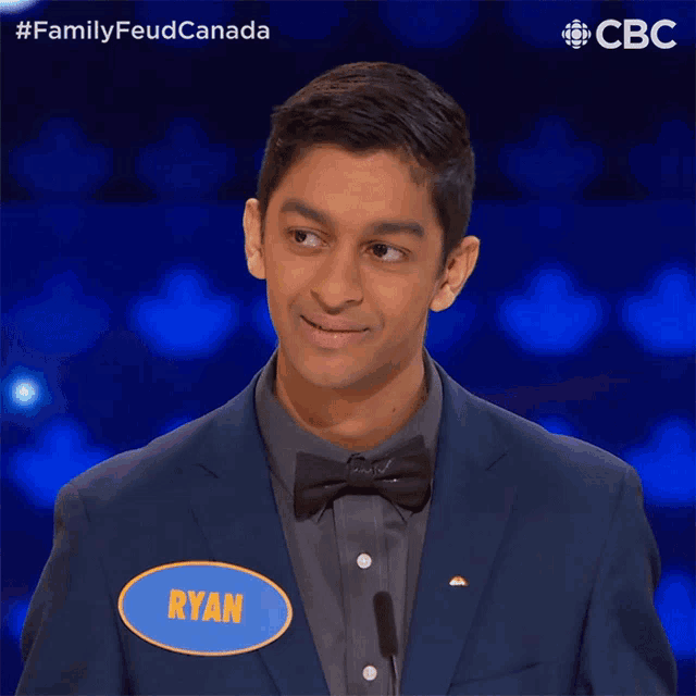 a man in a suit has a name tag that says ryan on it