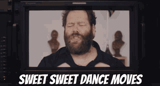 a man with a beard is on a screen with the words sweet sweet dance moves above him