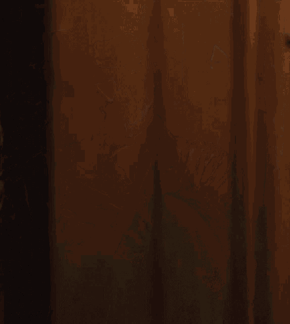 a man with a cigar in his mouth is wearing a brown jacket