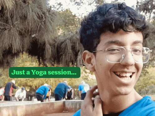 a young man with glasses is smiling in front of a sign that reads just a yoga session