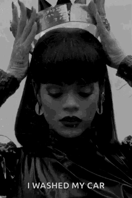 a black and white photo of a woman wearing a crown