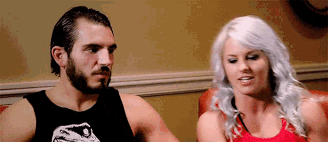 a man and a woman are sitting next to each other on a couch .