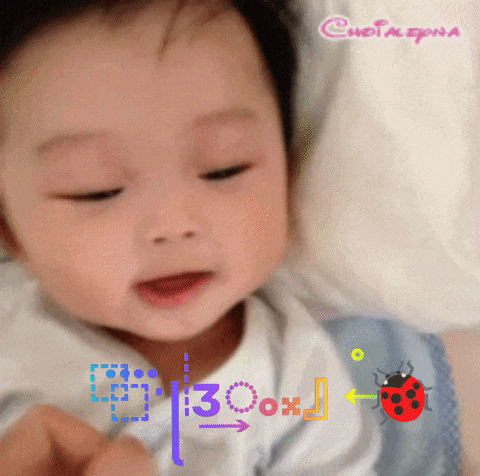 a baby 's face is shown with a ladybug and the number 30 on it