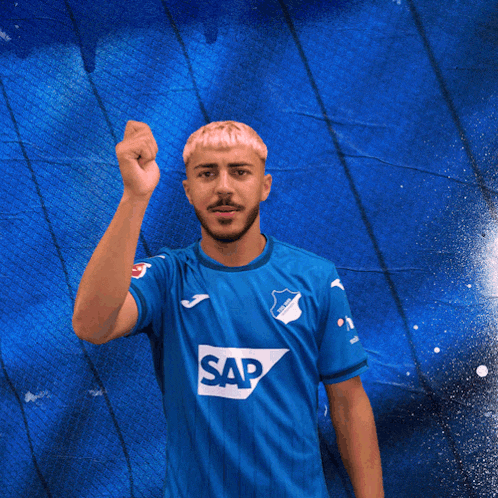 a man in a blue shirt with the word sap on the front