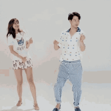 a man and a woman are holding hands while dancing together .