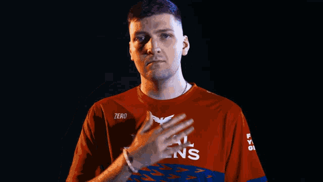 a man is wearing a red shirt that says royal ravens on it