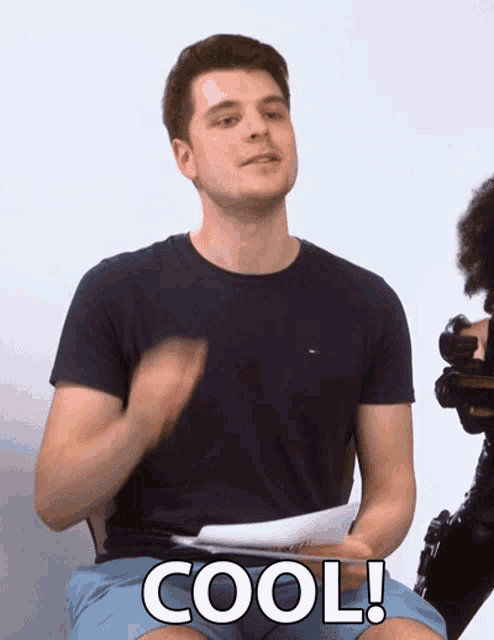 a man in a blue shirt and blue shorts says cool in white letters