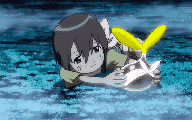 a little girl is laying on the ground holding a yellow flower
