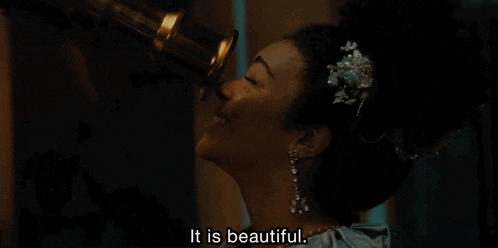 a woman looking through a telescope with the words " it is beautiful " written below her