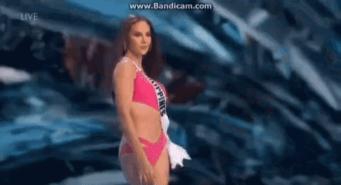 a woman in a bikini is standing on a stage .