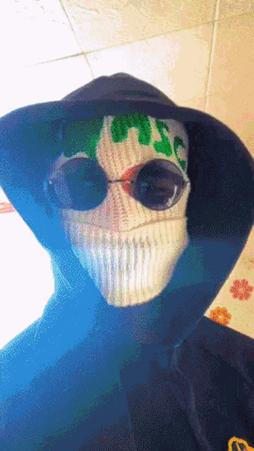 a person wearing sunglasses and a mask with the word misc on it