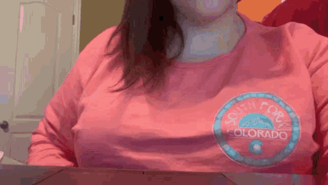 a woman in a pink shirt that says south forty colorado