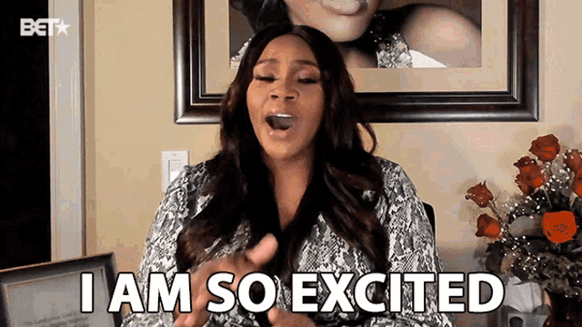a woman says i am so excited in front of a picture