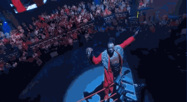 a man in a leopard print jacket is standing in front of a crowd with his arms outstretched