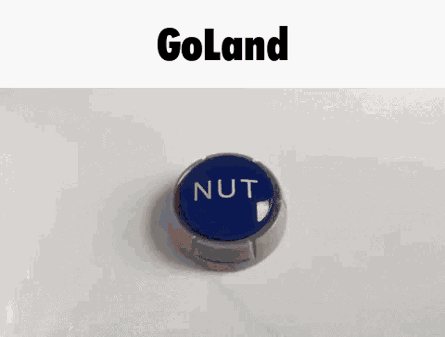 a blue button with the word nut written on it is sitting on a white surface .