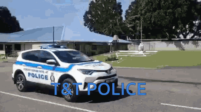 a white and blue police car with t & t police written on the side