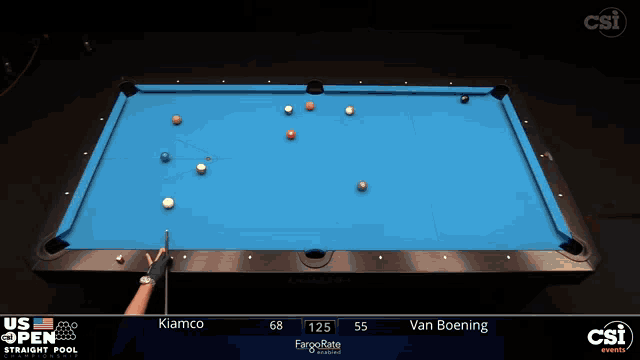 a pool table with a blue cloth and a person holding a cue