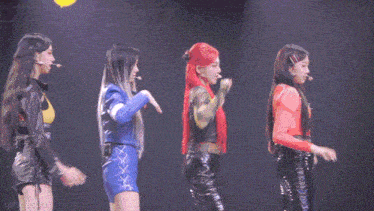 a group of young women are standing on a stage and one of them has red hair