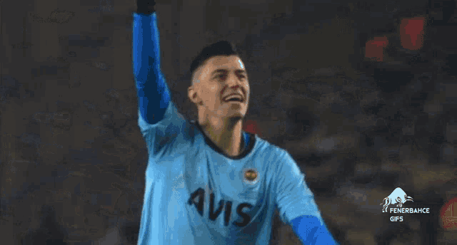 a soccer player wearing a blue avis jersey is kicking a ball