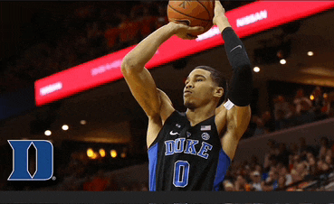 a duke basketball player is shooting a ball