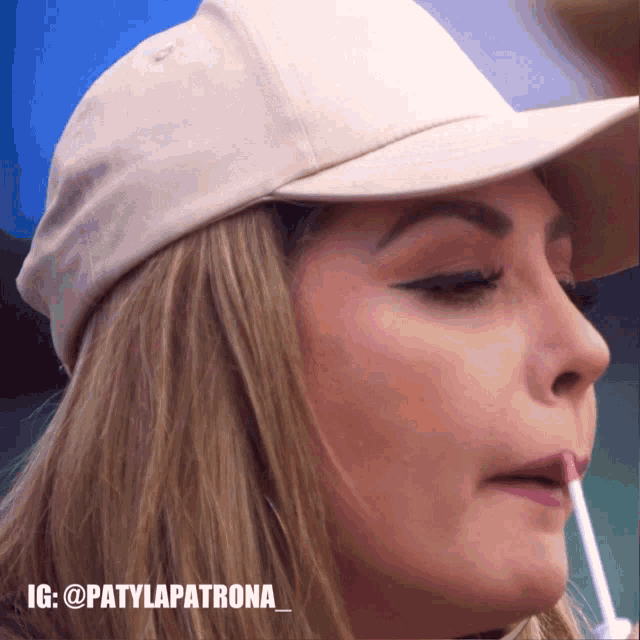 a close up of a woman applying lip gloss with the hashtag patylapatrona