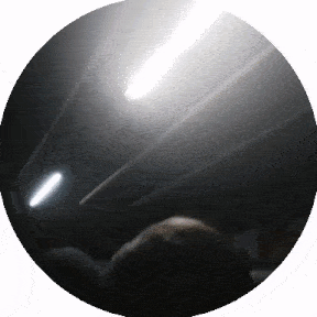 a dark circle with a white light shining through it