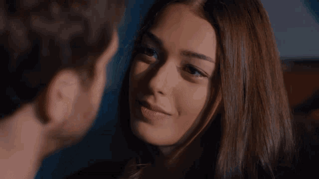 a man and woman are looking at each other and the woman is smiling
