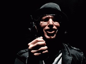 a man wearing a hat and sunglasses is holding a lighter
