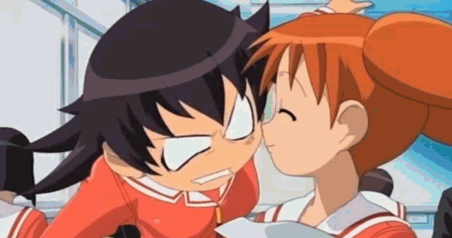 a girl is kissing another girl on the cheek .