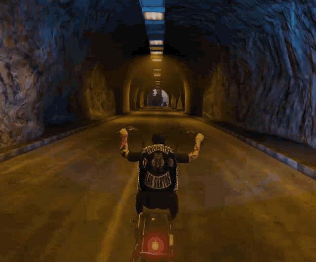 a man is riding a motorcycle through a tunnel with u.f.f.u. written on the bottom
