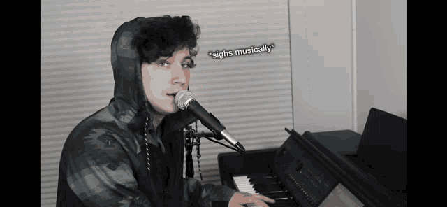 a person singing into a microphone while playing a piano