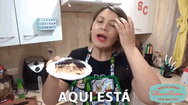 a woman holding a piece of cake in front of a sign that says silvana cocina