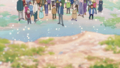 a person is walking on a dirt path with flowers in the background .