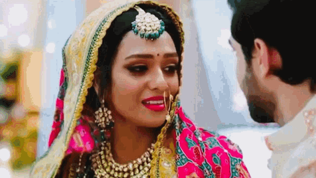 a close up of a bride and groom looking at each other