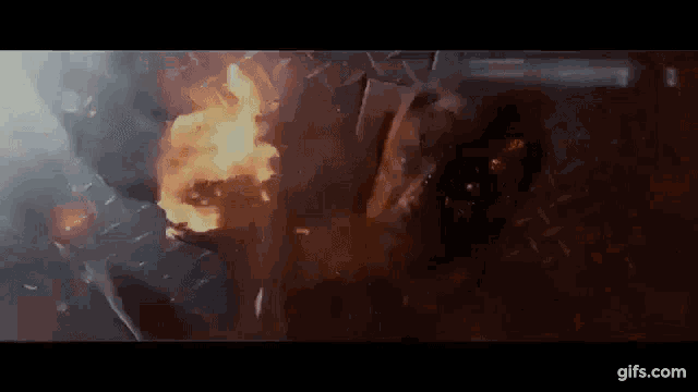 a person is laying on the ground with a fire coming out of their head .