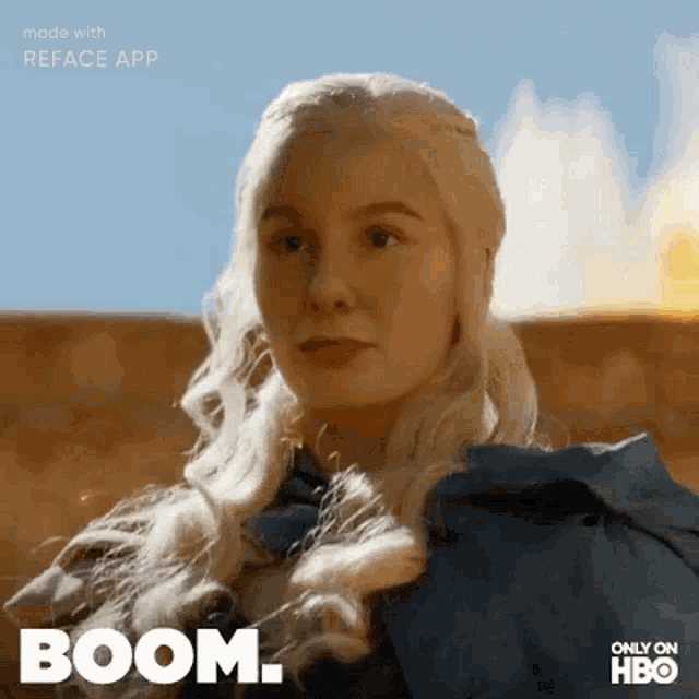 a woman with blonde hair and a blue cape says boom on her face