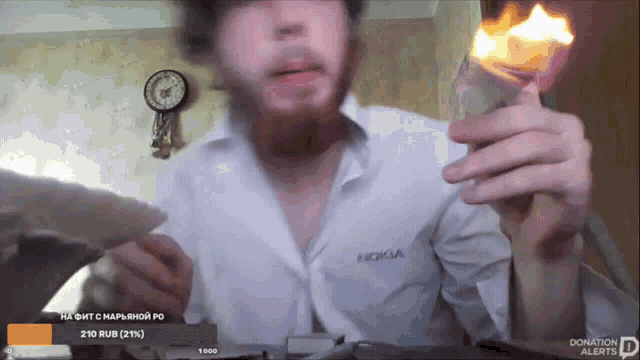 a man wearing a nokia shirt is holding a lighter