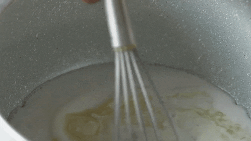 Mixing The Milk And Butter Two Plaid Aprons GIF - Mixing The Milk And Butter Two Plaid Aprons Stirring GIFs