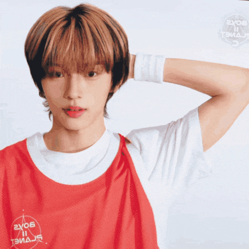 a young man wearing a red and white t-shirt that says 2x05 on it