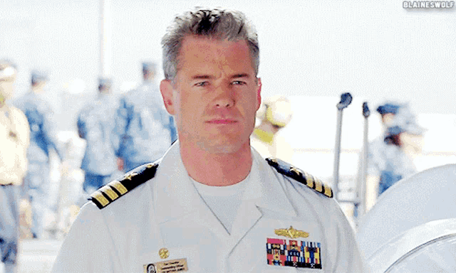 a man in a military uniform has a name tag that says ' blaine wolf '