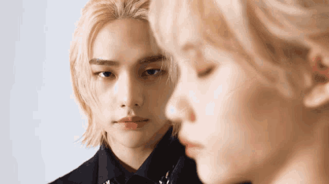 a man with blonde hair is standing next to a woman with blonde hair