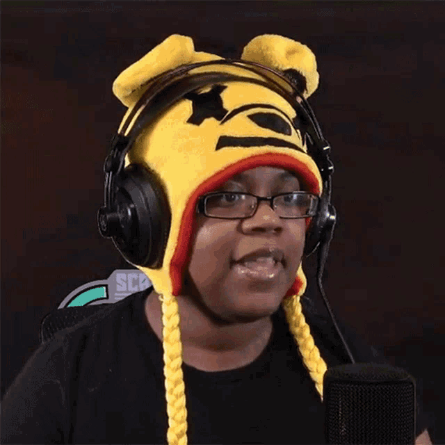 a woman wearing headphones and a winnie the pooh hat with ears