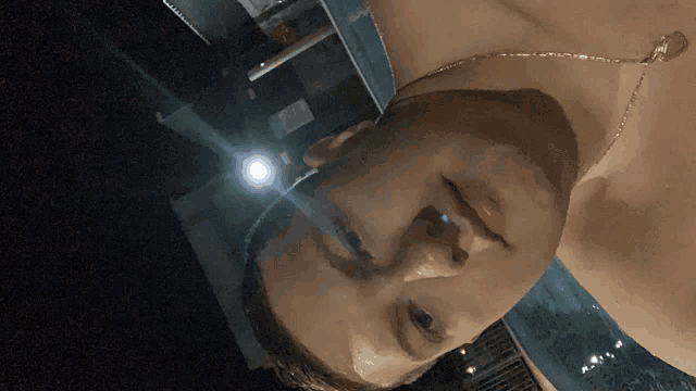 a man without a shirt is taking a picture of himself with a flashlight