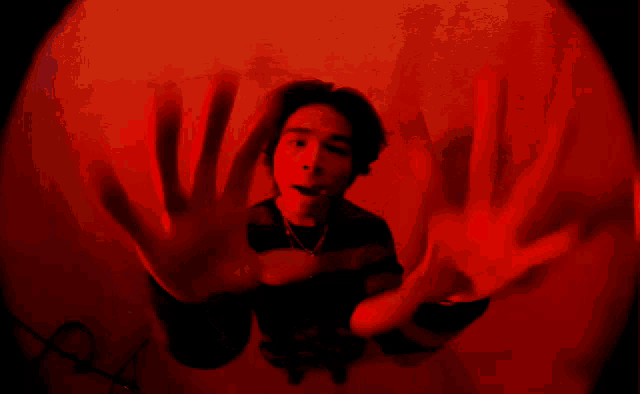 a person giving the middle finger in a red light